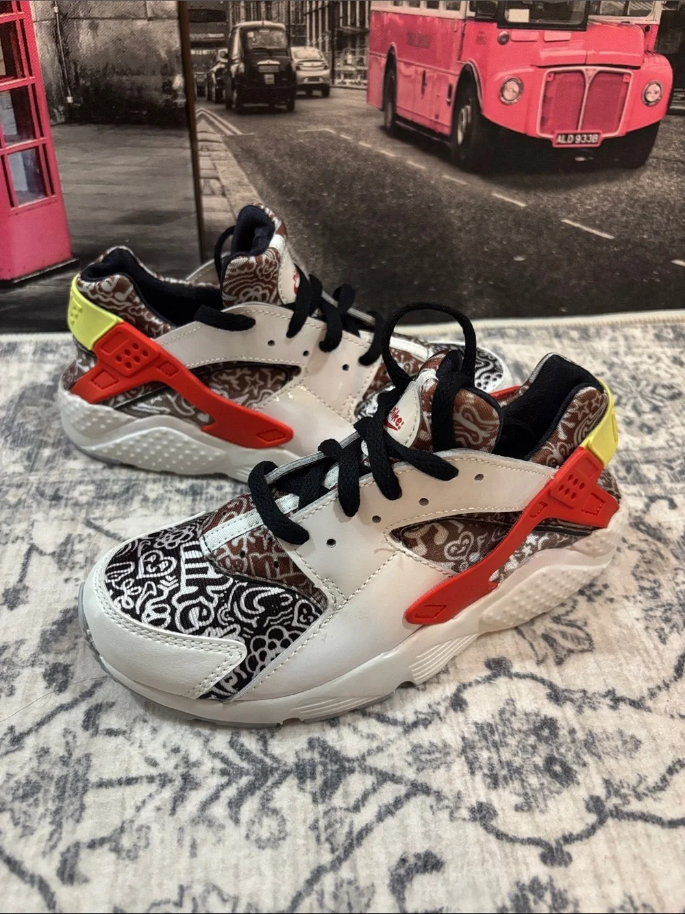 Nike Huarache Kids White Sneakers with Black Pattern, Orange & Yellow Accents